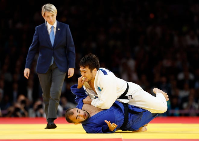 Yeldos Smetov (KAZ) defeats Luka Mkheidze (FRA) in the men's 60kg gold medal match during the Paris 2024 Olympic Summer Games at Champ-de-Mars Arena.