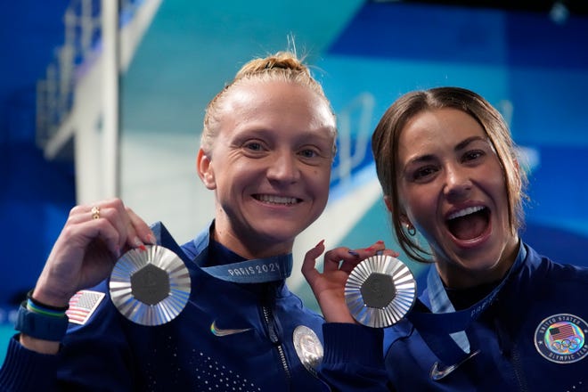 Sarah Bacon and Kassidy Cook (USA) celebrate after placing second and winning the silver medal in the women's 3m synchronized springboard diving competition during the Paris 2024 Olympic Summer Games at Aquatics Centre.