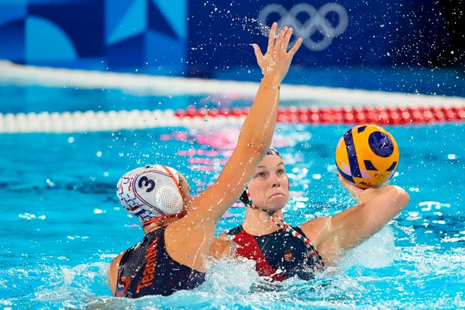 Hungary right wing Dora Leimeter (9) shoots the ball against Netherlands driver Brigitte Sleeking (3) in the women’s water polo group A play during the Paris 2024 Olympic Summer Games at Aquatics Centre.