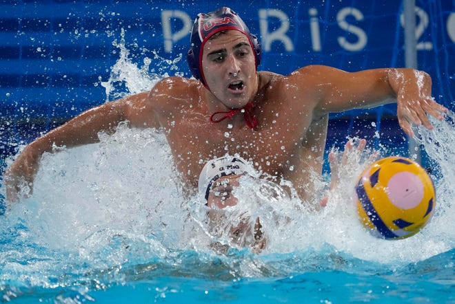 United States centre forward Luca Cupido (6) chases the ball against Italy driver Alessandro Velotto (3) in a water polo group stage match during the Paris 2024 Olympic Summer Games at Aquatics Centre.