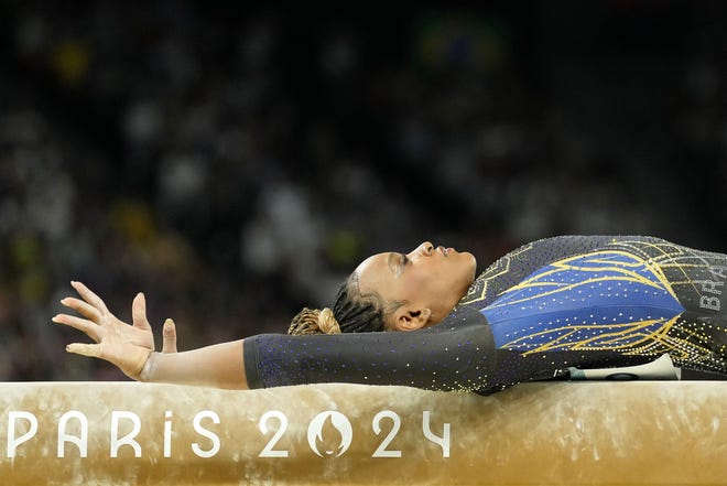 Rebeca Andrade of Brazil performs on the beam in womenÕs qualification during the Paris 2024 Olympic Summer Games at Bercy Arena.